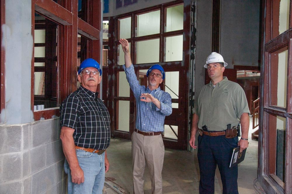 ATTENTION TO DETAIL: Stan Whitehurst, center, discusses work yet to be completed with Paul Ipock and Roye Cole.
